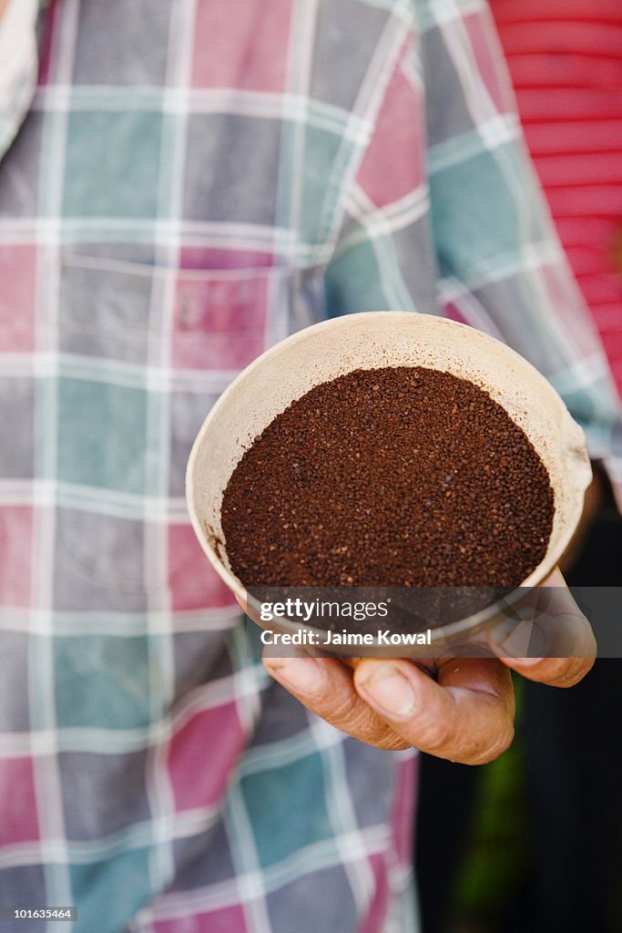 Organic coffee grinds in a coconut shell