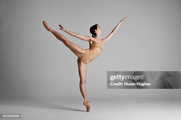 ballerina performing arabesque - arabesque position stock pictures, royalty-free photos & images