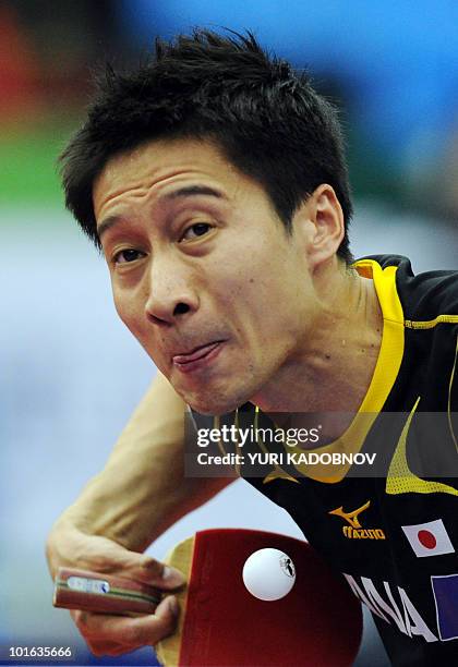 Kaii Yoshida of Japan returns a serve to Ma Lin of China during the men's semi final at the 2010 World Team Table Tennis Championships in Moscow on...