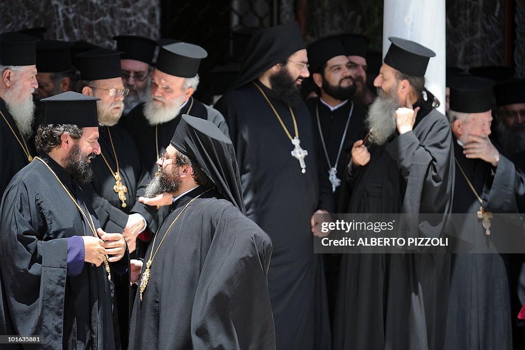 Orthodox priests wait for the arrival of