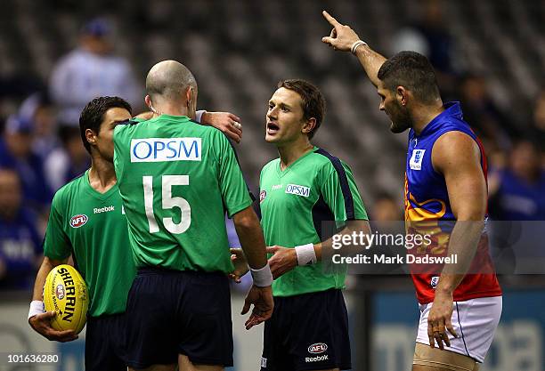 Brendan Fevola of the Lions tells Umpire Matthew Nicholls to look at the big screen replayduring the round 11 AFL match between the North Melbourne...
