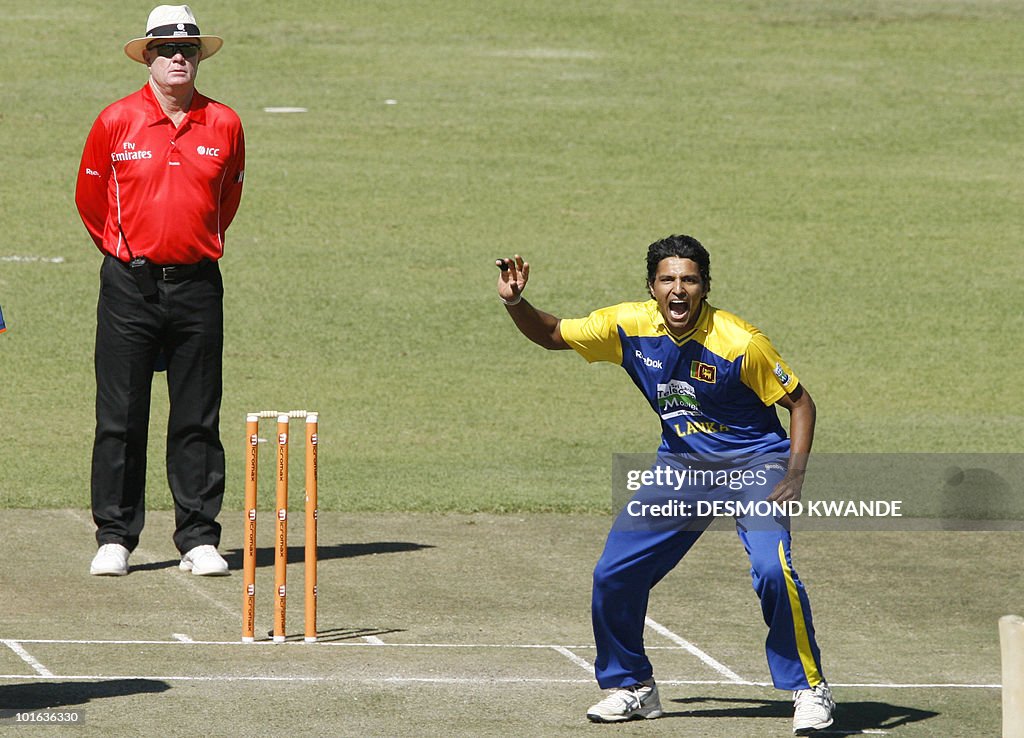 Sri Lankan bowler Suraj Randiv (R) makes