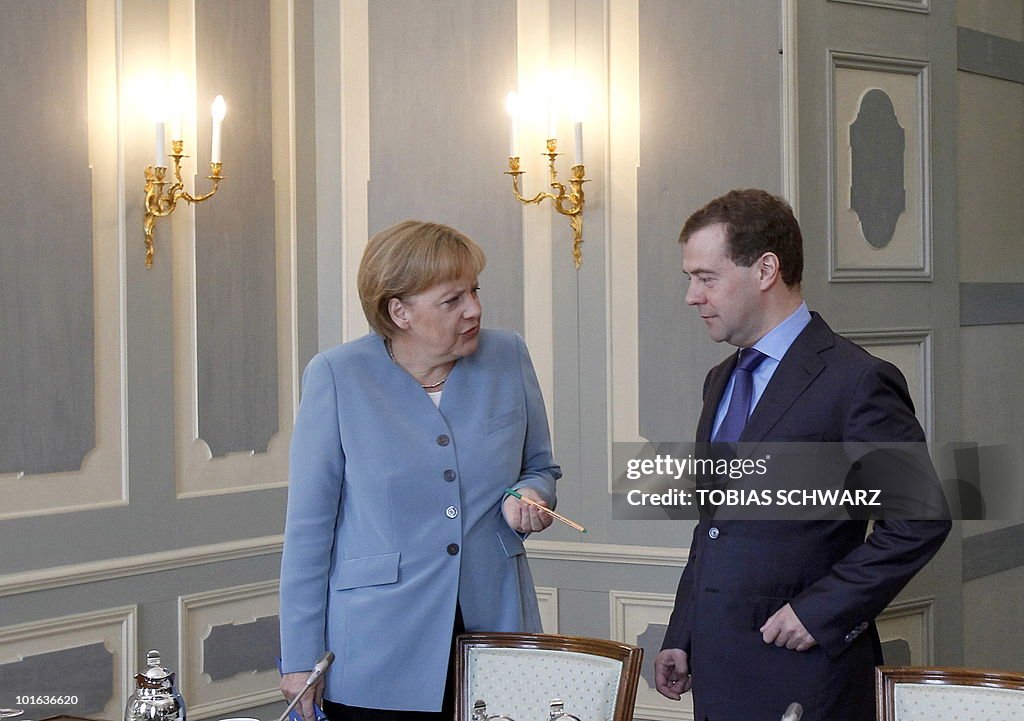 German Chancellor Angela Merkel chats wi