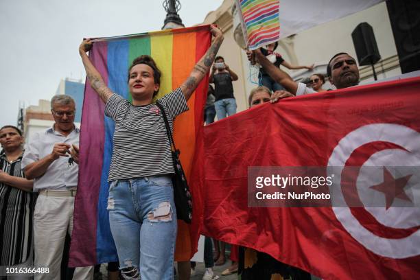 Amina Sboui, ex Femen rises the rainbow flag as she attends a demonstration held during the celebration of the National Womens Day in avenue Habib...