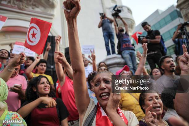Woman shouts slogans and rises her arm during the celebration of the National Womens Day in avenue Habib Bourguiba in Tunis, on August 13, 2018....