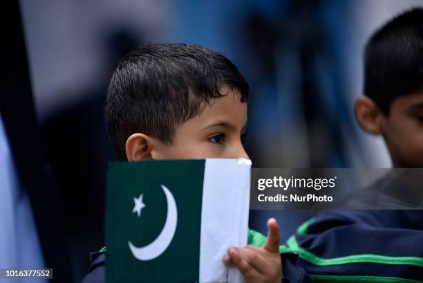 Kid hold Pakistan Flag during a special programme held on the eve of 71st Independence Day of Pakistan, at the Embassy of Pakistan in Maharajgunj,...