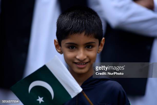 Kid hold Pakistan Flag during a special programme held on the eve of 71st Independence Day of Pakistan, at the Embassy of Pakistan in Maharajgunj,...