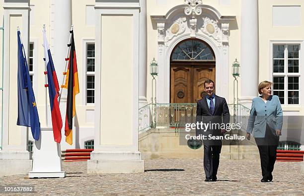German Chancellor Angela Merkel and Russian President Dmitry Medvedev arrive to speak to the media following bilateral talks at Meseberg Palace on...