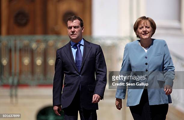 German Chancellor Angela Merkel and Russian President Dmitry Medvedev arrive to speak to the media following bilateral talks at Meseberg Palace on...