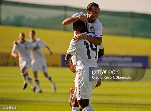 Edson Buddle of USA is congratulated by teammate Landon Donovan after scoring a goal against Australia during first half of the 2010 FIFA World Cup...