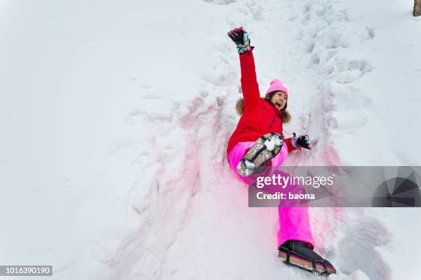 woman falling down on the snow road - pedestrian winter stock pictures, royalty-free photos & images