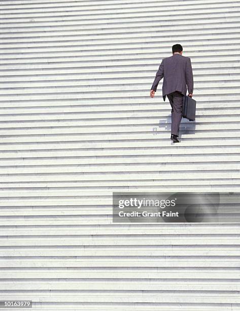 businessman walking up stairs - salire le scale foto e immagini stock