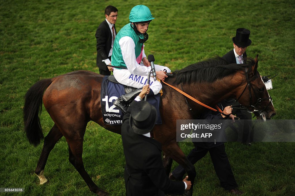 British jockey Ryan Moore (C) and horse