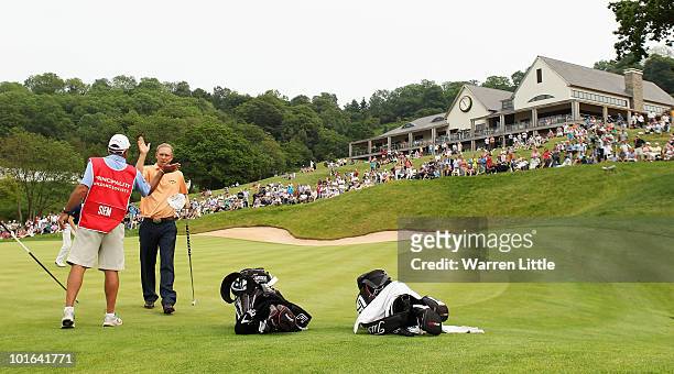 Marcel Siem of Germany is congratulated by his caddie Kyle Roadley on the 18th green during the third round of the Celtic Manor Wales Open on The...