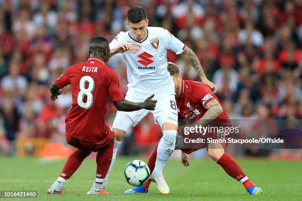 Daniele Baselli of Torino battles with Naby Keita of Liverpool and Alberto Moreno of Liverpool during the pre-season friendly match between Liverpool...