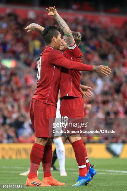 Roberto Firmino of Liverpool celebrates with teammate Alberto Moreno of Liverpool after scoring their 1st goal during the pre-season friendly match...