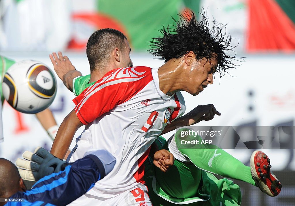 Algeria's Djebbour Rafik (back) and Emir