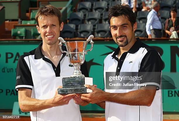 Nenad Zimonjic of Serbia and Daniel Nestor of Canada celebrate with the trophy after their match against Lukas Dlouhy of the Czech Republic and...