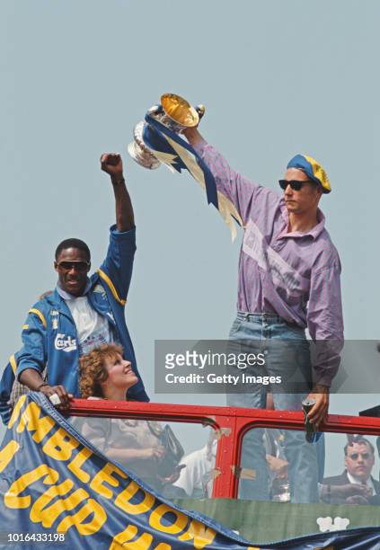 Wimbledon players John Fashanu and Vinnie Jones celebrate with the FA Cup Trophy on their open top bus parade after their famous 1-0 FA Cup Final win...