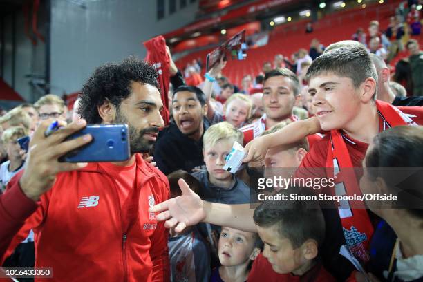 Fans clamour to get a selfie with Mohamed Salah of Liverpool after the pre-season friendly match between Liverpool and Torino at Anfield on August 7,...