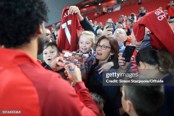 Woman and young girl get an autograph from Mohamed Salah of Liverpool after the pre-season friendly match between Liverpool and Torino at Anfield on...