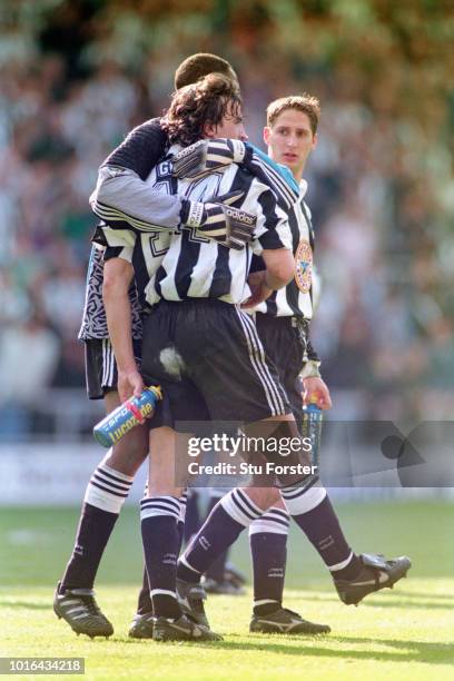 Newcastle United player David Ginola is consoled by goalkeeper Shaka Hislop as team mate Robbie Elliott looks on after Newcastle could only draw with...