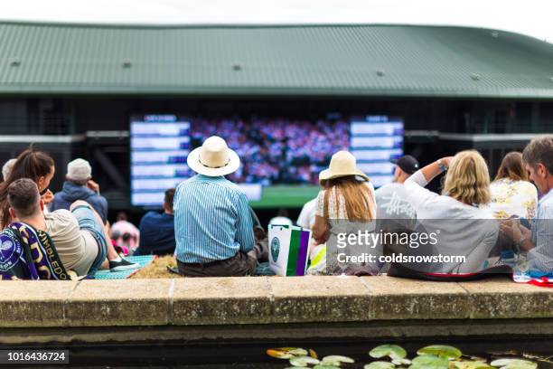 crowd of people enjoying tennis on the hill, wimbledon, uk - wimbledon tennis stock pictures, royalty-free photos & images