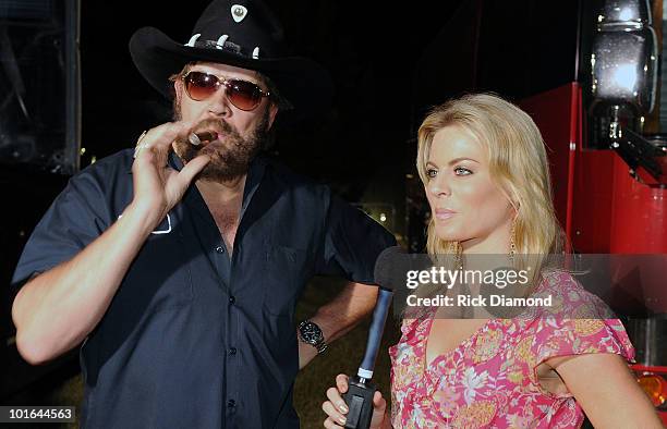 Singer/Songwriter Hank Williams Jr. And FOX National TV Personility Courtney Friel backstage during the 2010 BamaJam Music & Arts Festival at the...
