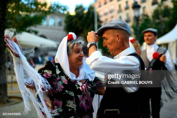 Couple dressed in Madrid's traditional attire "Chulapos" dance during the Feast of La Paloma Virgin in Madrid on August 13, 2018. - Madrid's history...