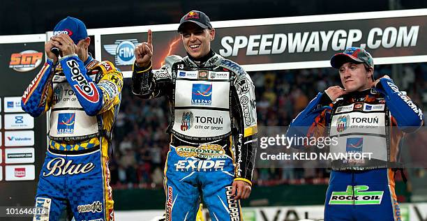 Poland's Jaroslaw Hampel signs he is number one after winning the Danish Speedway Grand Prix on the podium with second placed Tomasz Gollob of Poland...