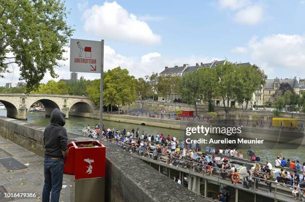 View of a local public urinal on Ile Saint Louis along the river Seine on August 14, 2018 in Paris, France. The eco-friendly Uritrottoir public...