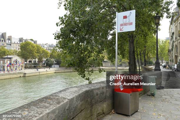 View of a local public urinal on Ile Saint Louis along the river Seine on August 14, 2018 in Paris, France. The eco-friendly Uritrottoir public...