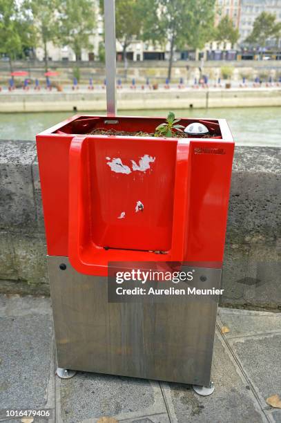 View of a local public urinal on Ile Saint Louis along the river Seine on August 14, 2018 in Paris, France. The eco-friendly Uritrottoir public...