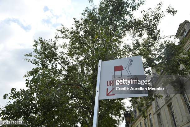 View of a local public urinal on Ile Saint Louis along the river Seine on August 14, 2018 in Paris, France. The eco-friendly Uritrottoir public...