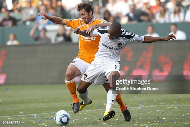 Tristan Bowen of the Los Angeles Galaxy battles for the ball with Brian Mullan of the Houston Dynamo on June 5, 2010 at the Home Depot Center in...