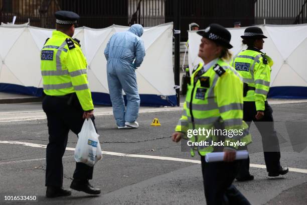 General view of police and forensic officers at the scene where a vehicle crashed into security barriers injuring a number of pedestrians early this...