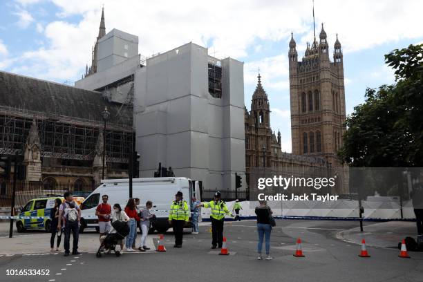 General view of police and forensic officers at the scene where a vehicle crashed into security barriers injuring a number of pedestrians early this...