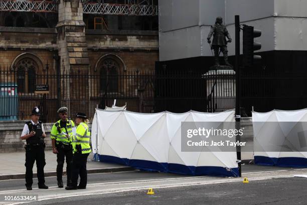 General view of police and forensic officers at the scene where a vehicle crashed into security barriers injuring a number of pedestrians early this...