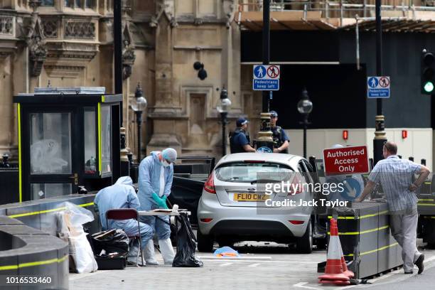 General view of forensic officers with the vehicle that crashed into security barriers, injuring a number of pedestrians early this morning, outside...