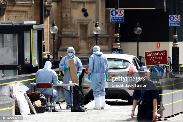 General view of forensic officers with the vehicle that crashed into security barriers, injuring a number of pedestrians early this morning, outside...