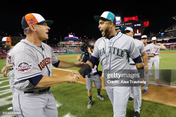 Manager AJ Hinch of the Houston Astros celebrates withNelson Cruz of the Seattle Mariners after defeating the National League 8-6 in the 89th MLB...