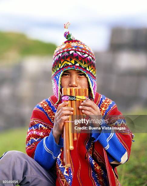 quechua indian boy playing flute, peru - quechuas fotografías e imágenes de stock