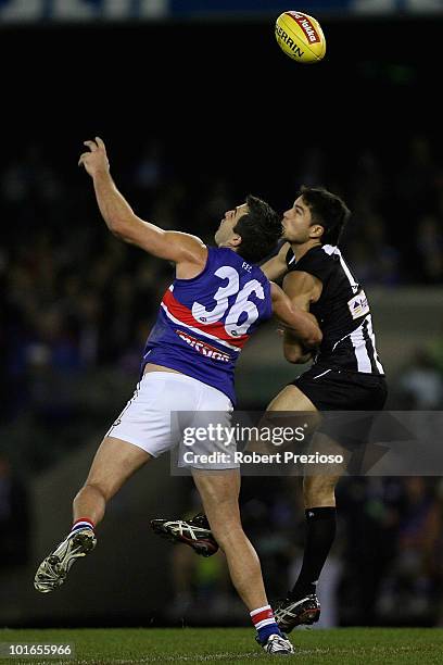 Brian Lake of the Bulldogs and Paul Medhurst of the Magpies contest the ball during the round 11 AFL match between the Collingwood Magpies and the...