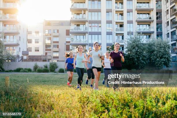 group of women jogging outdoors - german indian society stock pictures, royalty-free photos & images