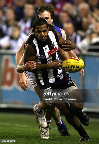 Leon Davis of the Magpies is tackled during the round 11 AFL match between the Collingwood Magpies and the Western Bulldogs at Etihad Stadium on June...