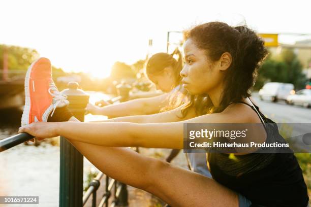 young woman stretching with he fitness group - running shoes sky stock pictures, royalty-free photos & images