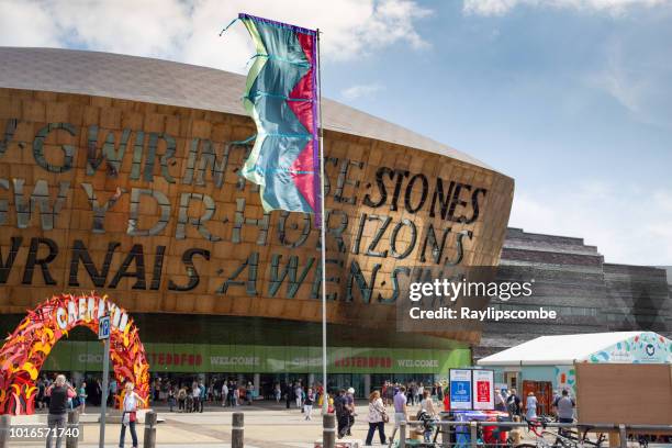 visitors exploring the 2018 eisteddfod walking around the millennium centre. it was built to celebrate the diversity of welsh culture. - eisteddfod stock pictures, royalty-free photos & images