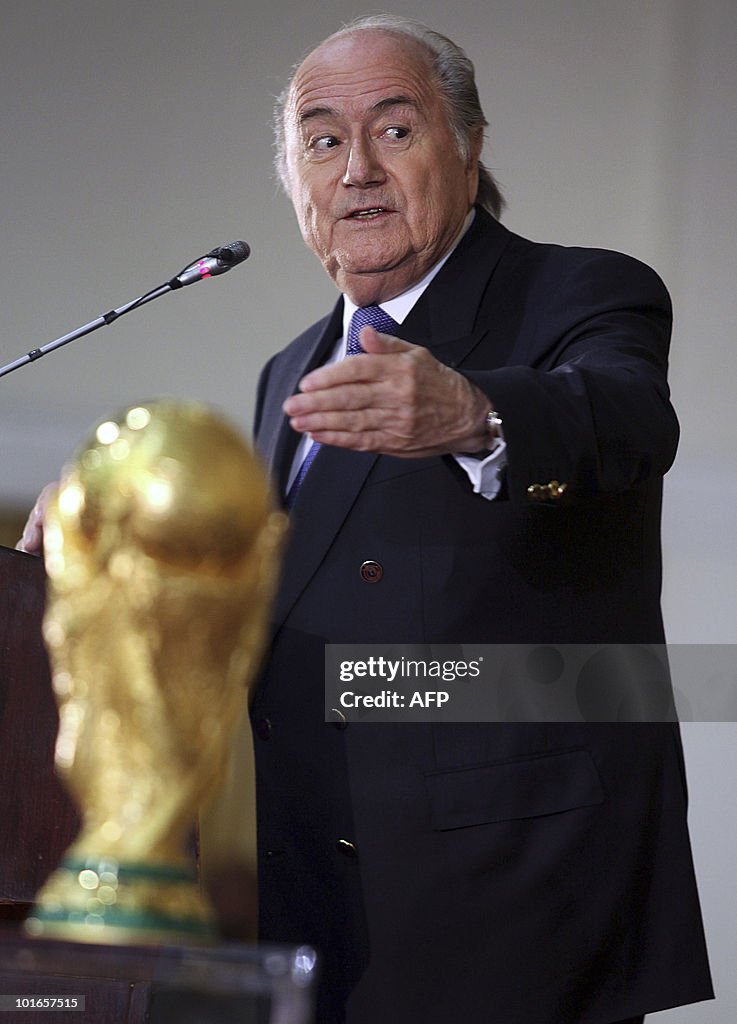 FIFA president Sepp Blatter points towar