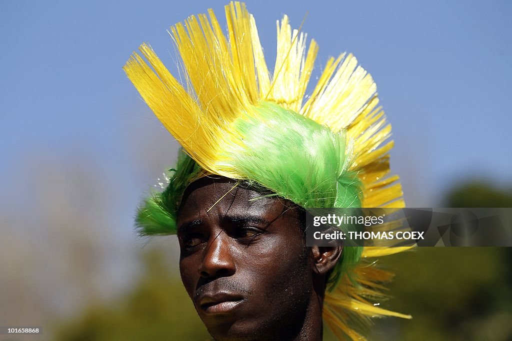 A man wears a headdress as he sells flag