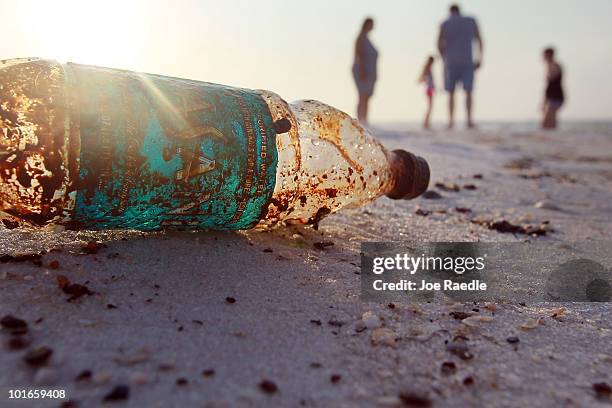 Plastic bottle is seen coated in oil on Pensacola Beach as oil makes its way on shore from the Deepwater Horizon oil spill in the Gulf of Mexico on...